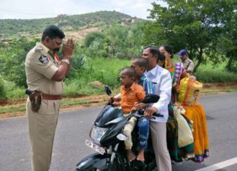 Andhra cop folds hands in front of a family of 5 members riding a bike