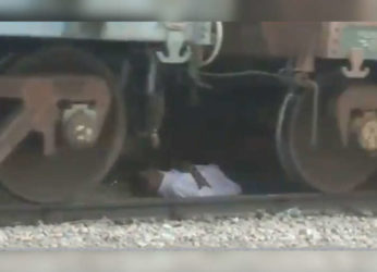 Watch video: Man escapes unhurt after being stuck under a moving train in Andhra Pradesh