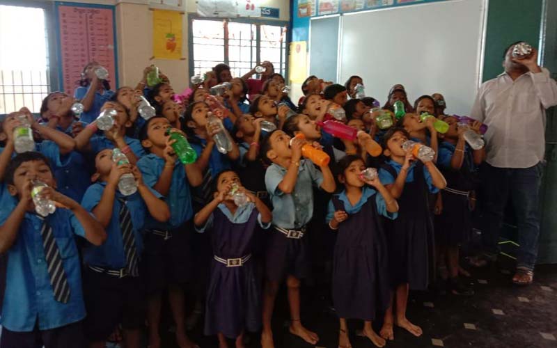 GVMC school children drinking water as part of water bell initiative in Visakhapatnam