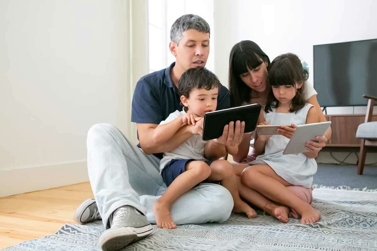 Image of a Family using digital devices, emphasizing cybersecurity education and awareness